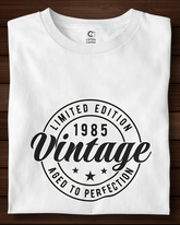 White t-shirt with black vintage design on a wooden surface